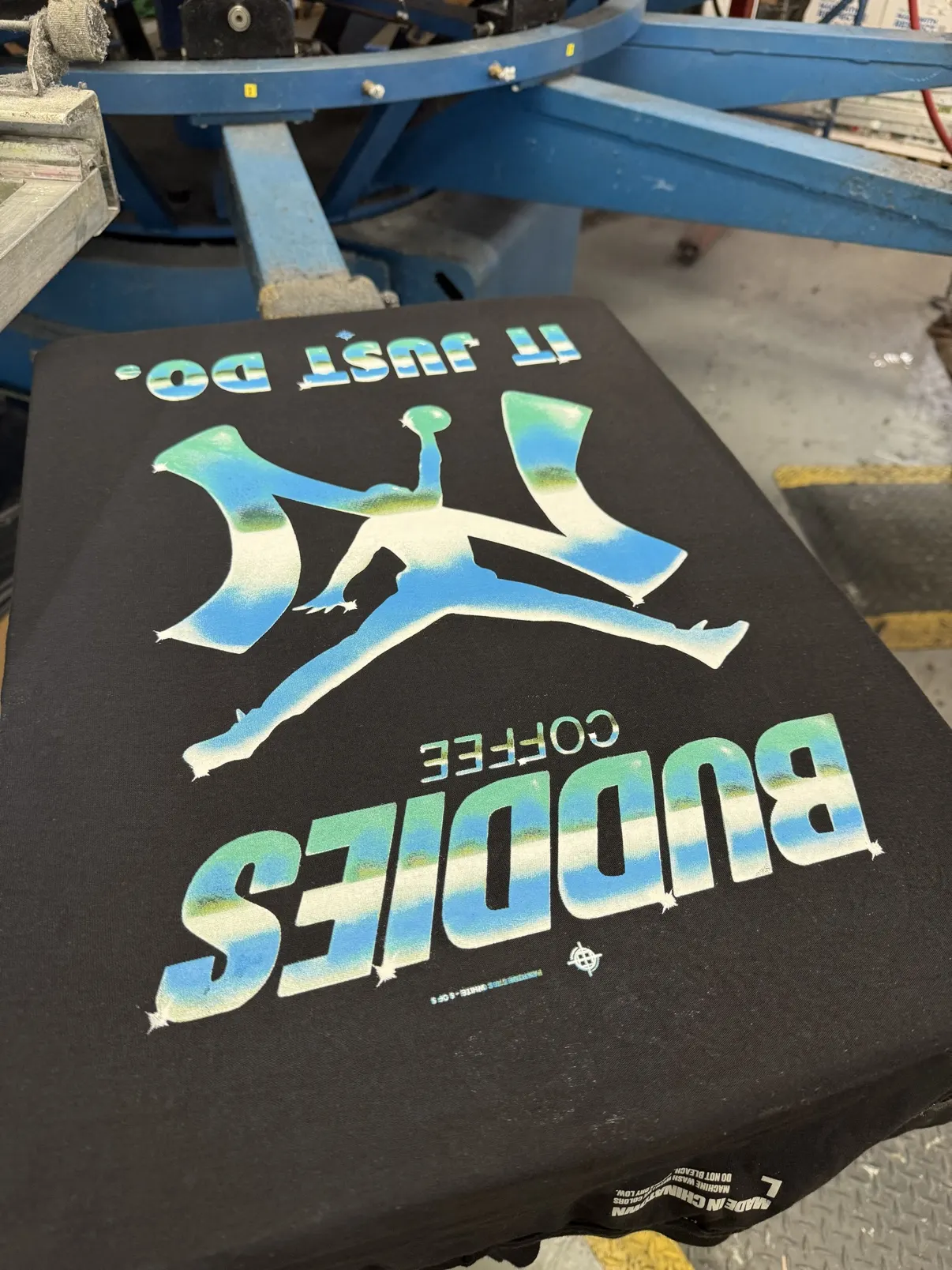 A tee on the automatic press mid-print in the Greenpoint shop