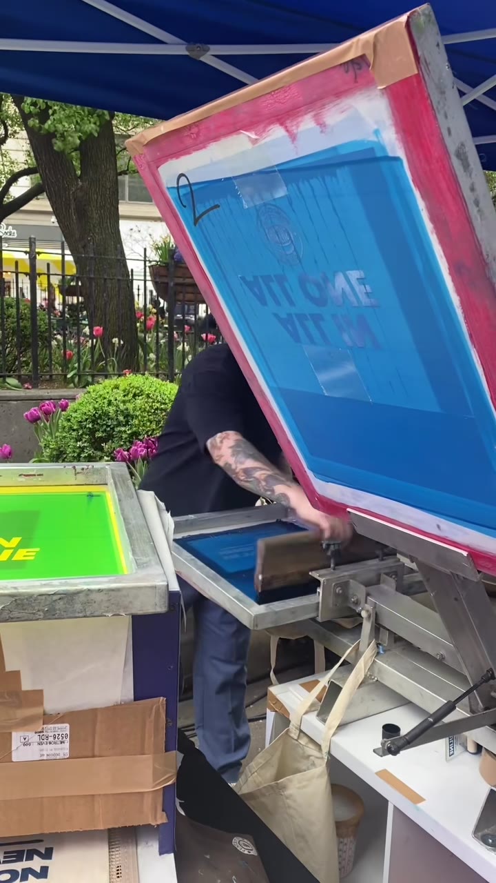Close-up of a squeegee pull on the press under the event tent